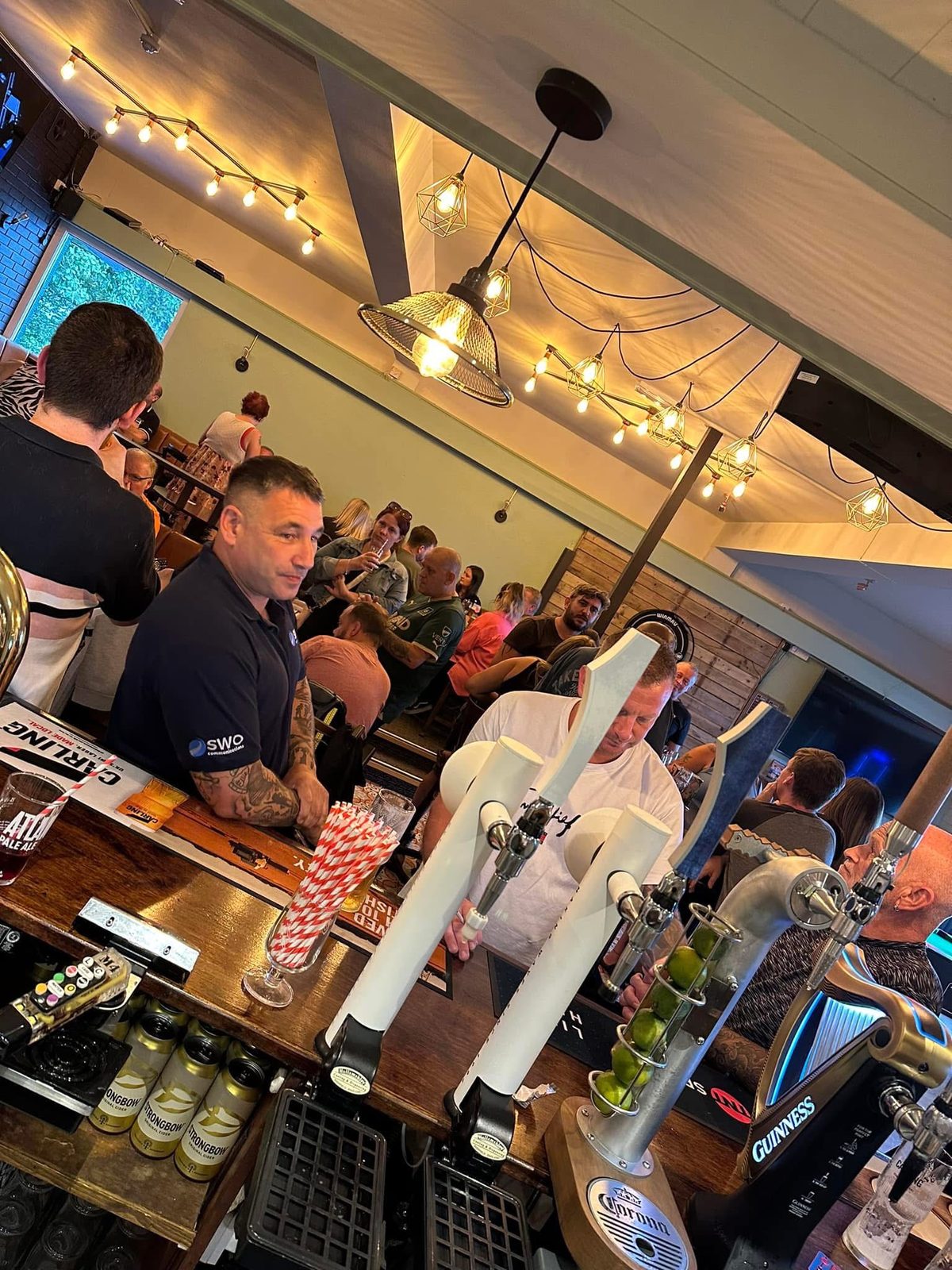 Busy bar and customers at The Falstaff Inn